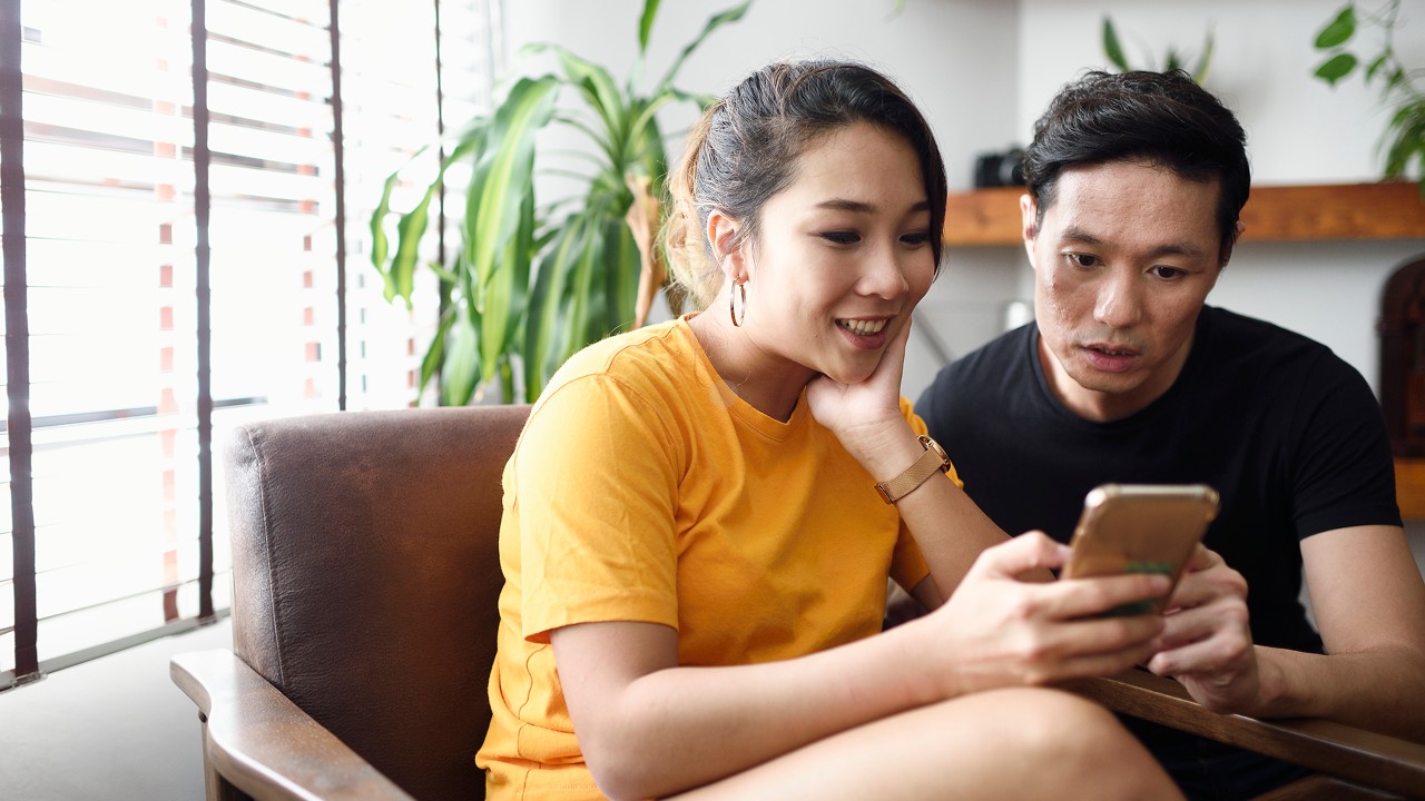 A couple using mobile device together