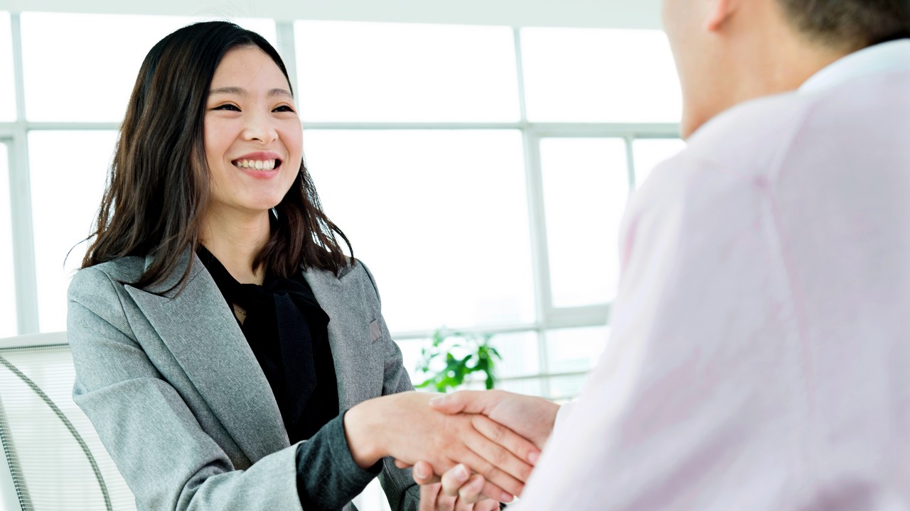 A lady is handshaking with a man; image used for Branch Banking.