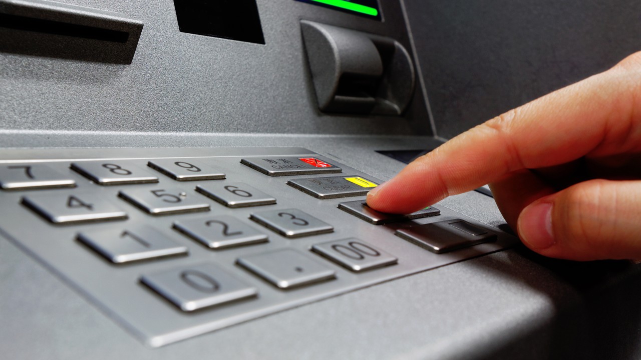 Pressing button in atm; image used for HSBC Express Banking.