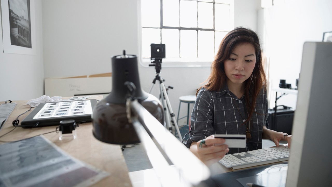 A woman is shopping online with credit card; image used for Transaction Dispute.