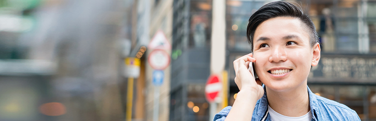 A man is talking on the phone in street.; image used for HSBC Phone Banking.