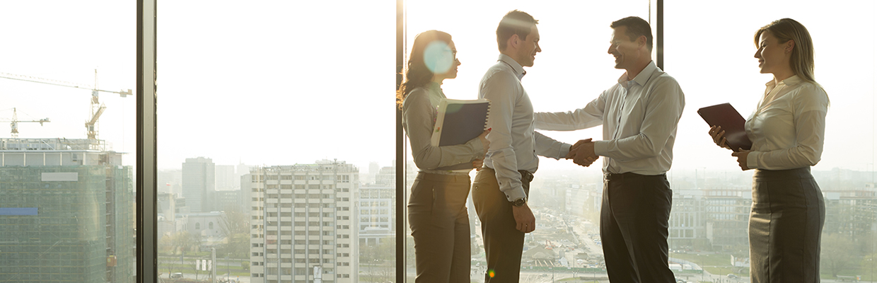 A manager introducing his teammates to a new joiner; image used in about HSBC Broking page