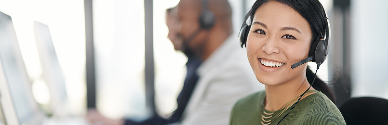 A smiling woman who is having a phone call; image used in contact us page