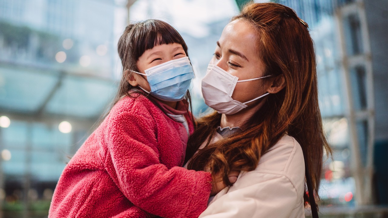 Mother and daughter wearing mask; image used for Coronavirus (COVID-19) guidance and support.