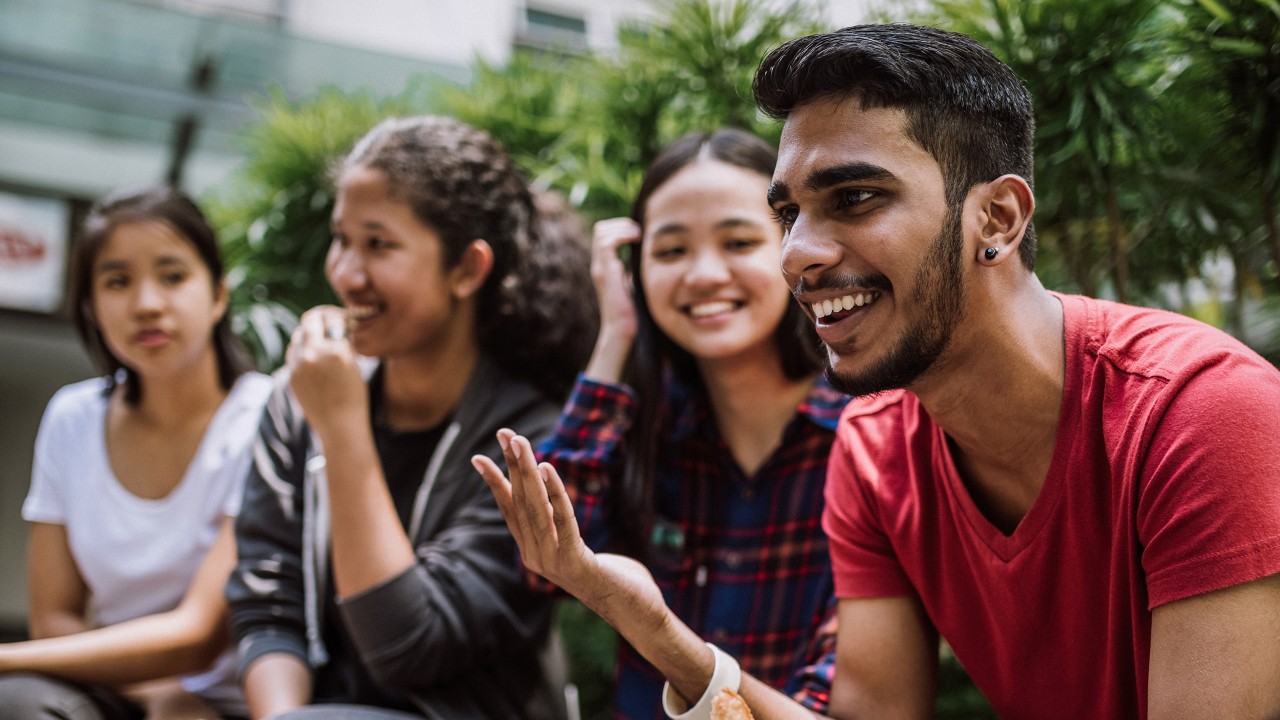 A group of students joking; image used for Basic Banking For Ethnic Minority Customers.