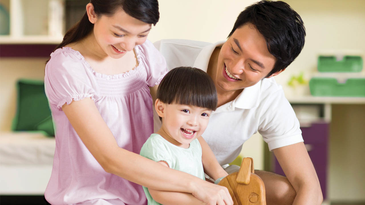 Family riding wooden horse; image used for HSBC Comprehensive Critical Illness Protection Plan