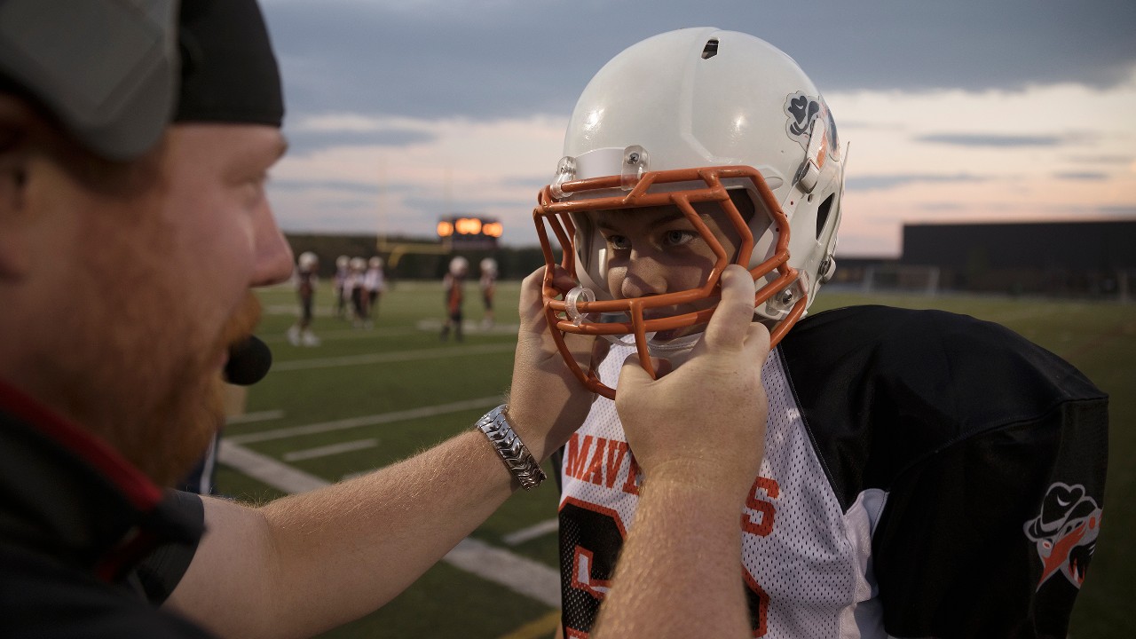 A boy equipped to play American football