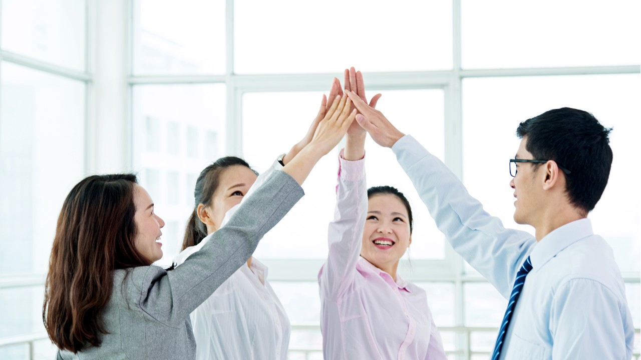 Four people are claping their hands to cheer up, image used for "Advice on starting a business" article