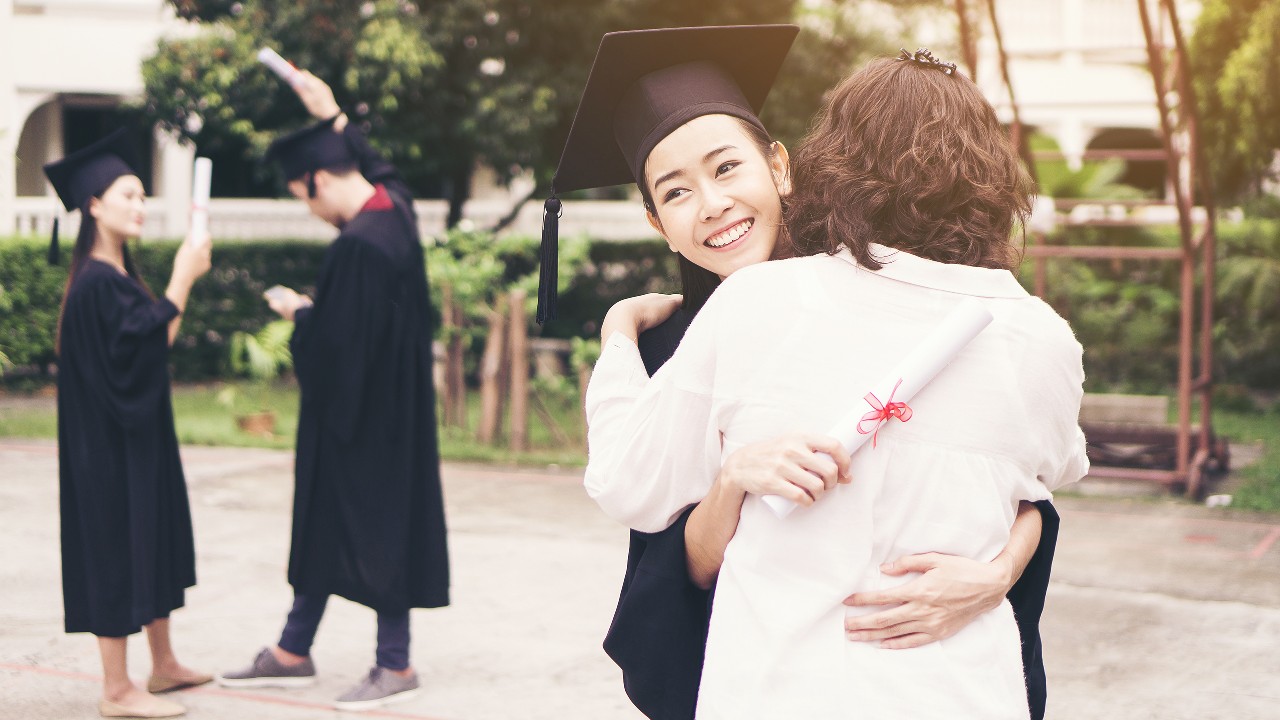 Daughter is hugging her mother in graduation ceremony, image used for "Important things to consider when studying abroad" article