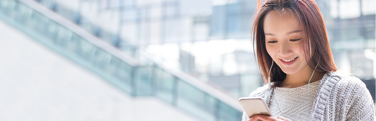 A girl is looking at her phone, image used for "Tax Loan Strategy!" article