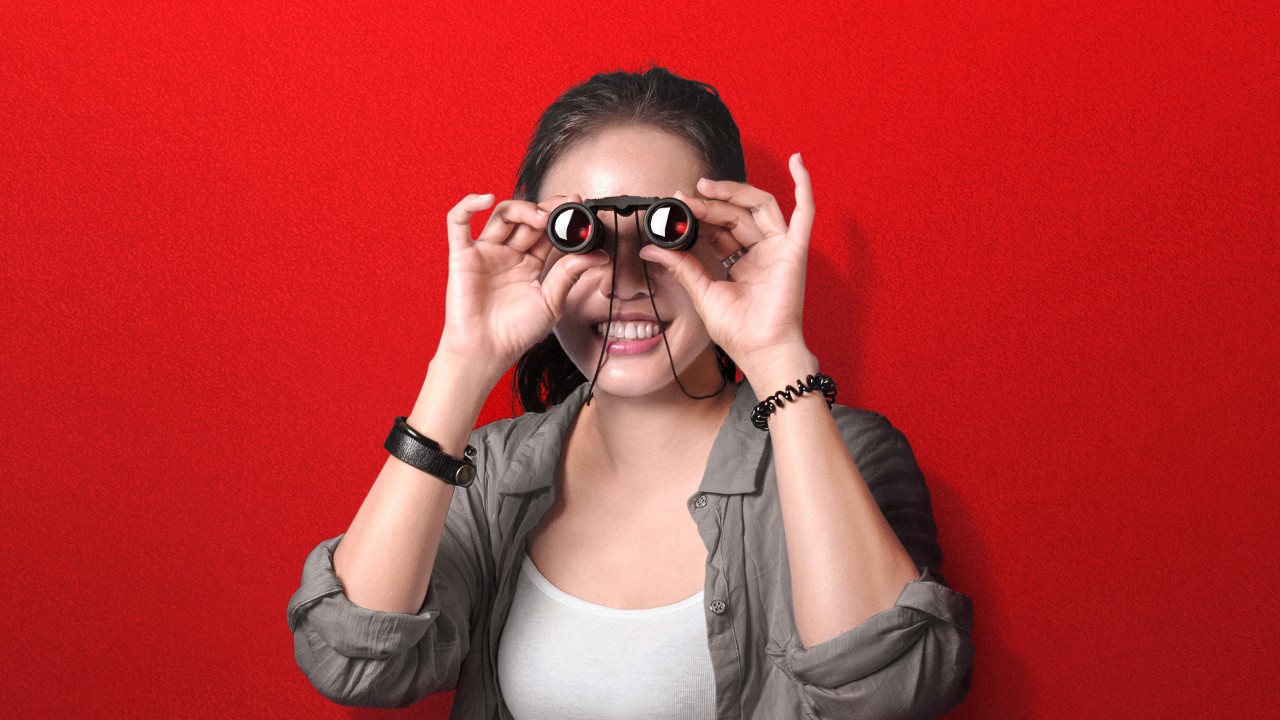 Young lady using a binocular; image used for HSBC One