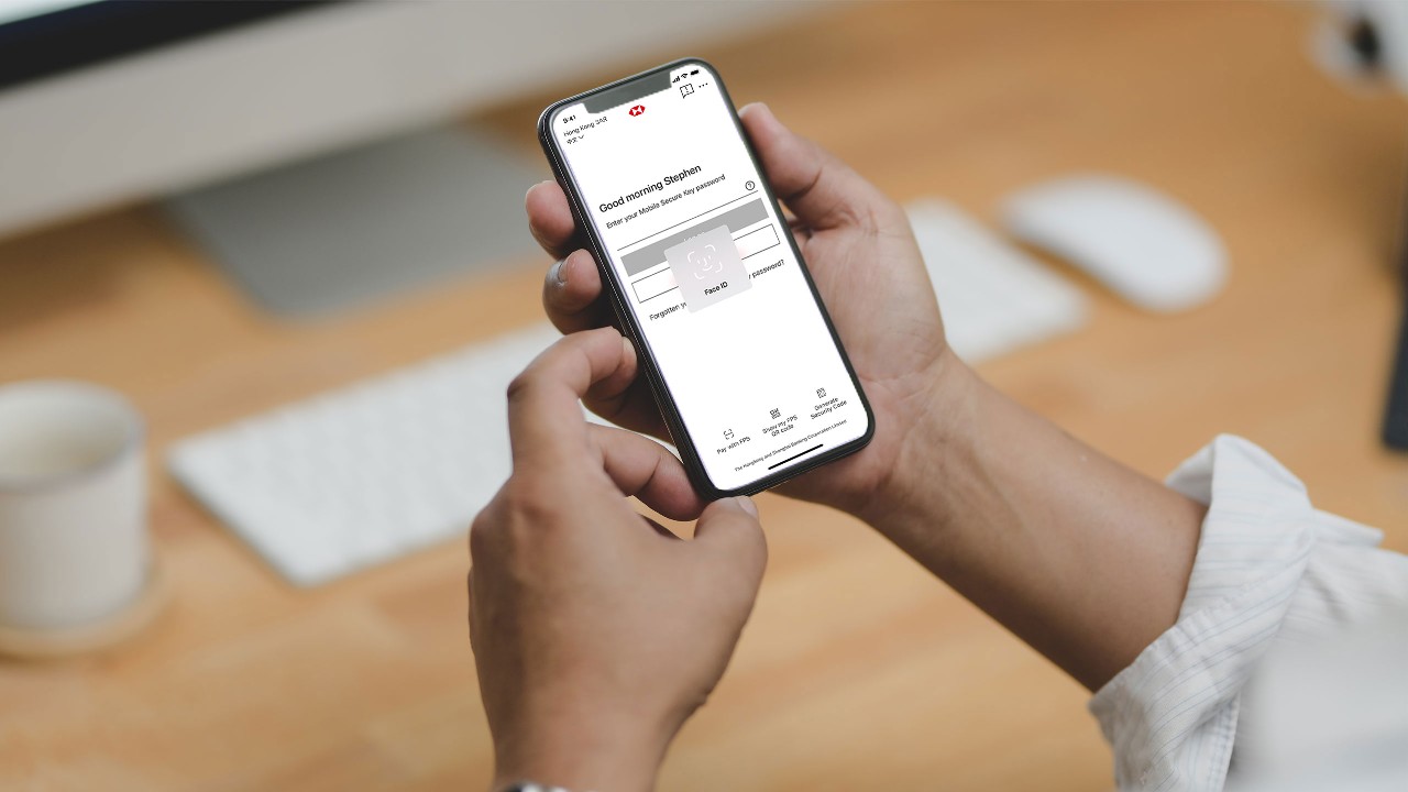 A person is using hsbc mobile app; image used for mobile security key .