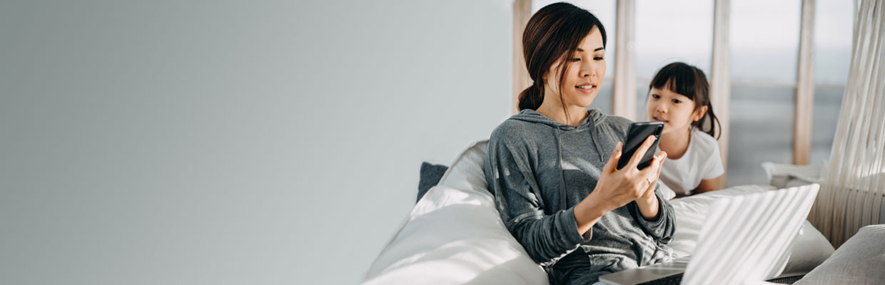 A woman is using her smartphone; image used for scan to pay government bills.