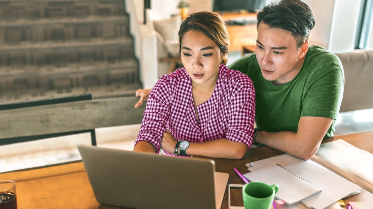 A couple are watching the computer; image used for Savings insurance plans.