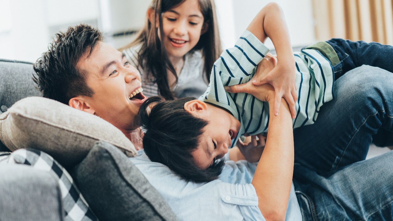 Family having fun tickling each other; image used for HSBC ResidenceSurance.