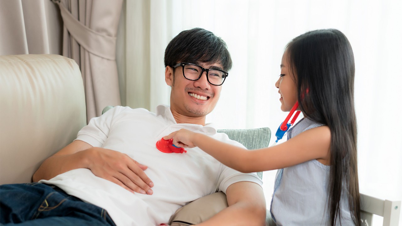 a daughter pretending having a health check on her dad.