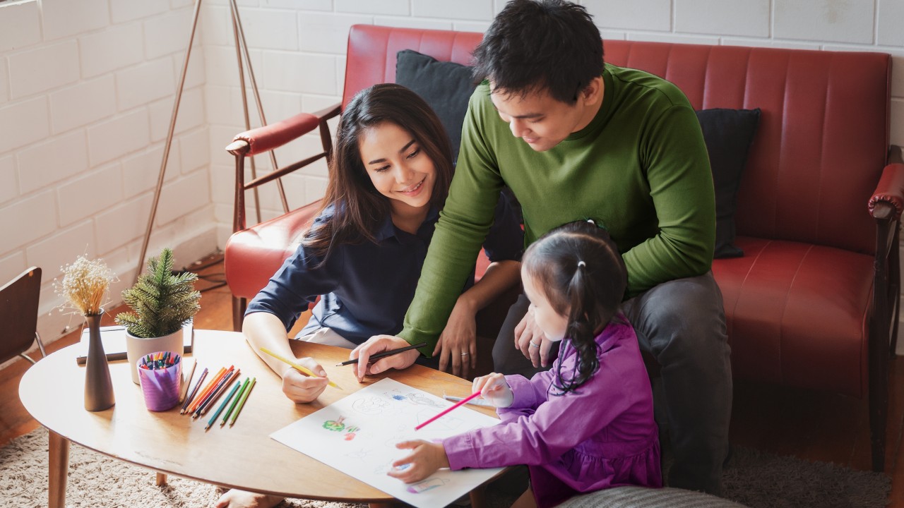 Parent teaching child; image used for HSBC Insurance "Stay protected with us".