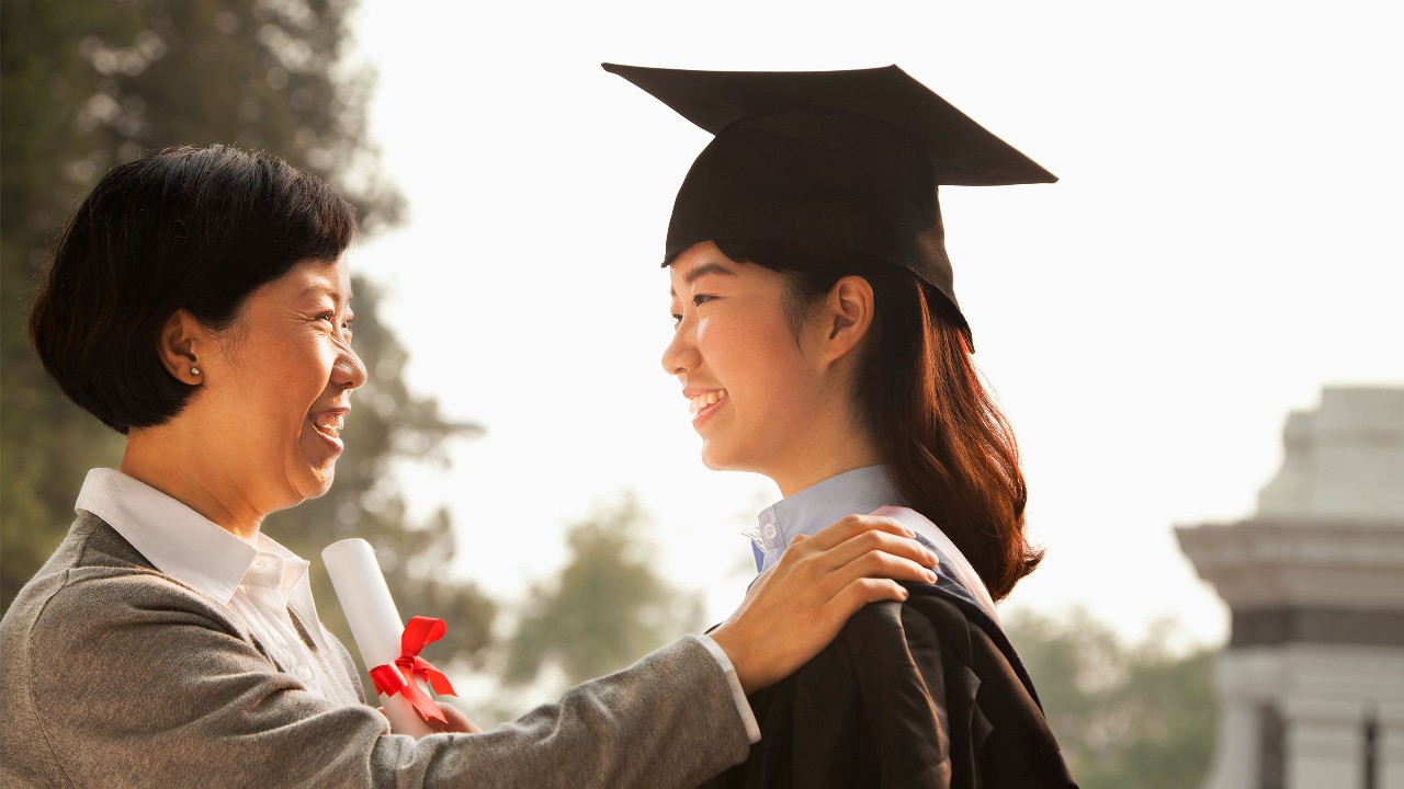 Mother is looking at her graduated daughter; image used for overseas education planning and support.