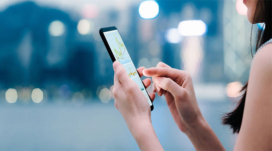 A woman using her mobile device; image used for foreign exchange