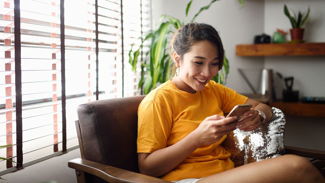 A woman is using her smart phone
