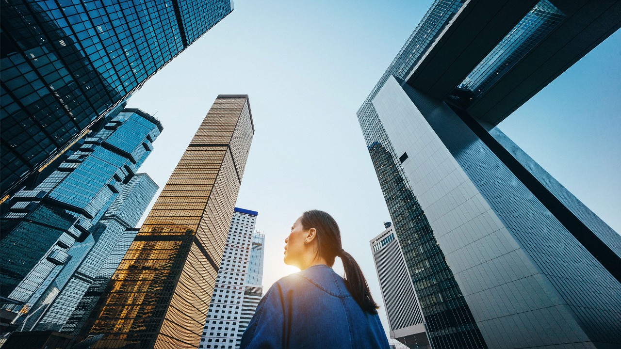A woman looking up into the sky; image used for wealth insights
