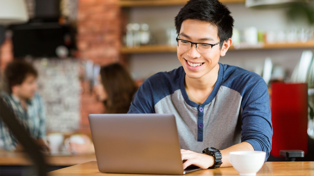 man using a laptop in cafe