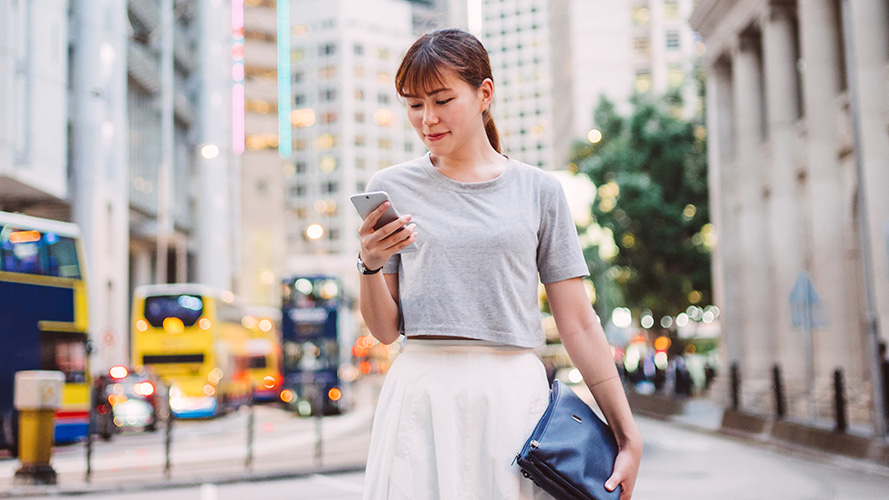 lady using smartphone in business district