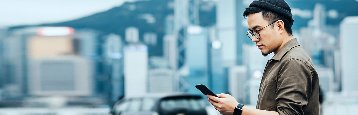 A man is looking at his smartphone; image used for HSBC Ways to Bank Page.