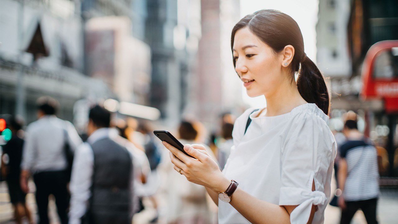 The lady is checking the smartphone.