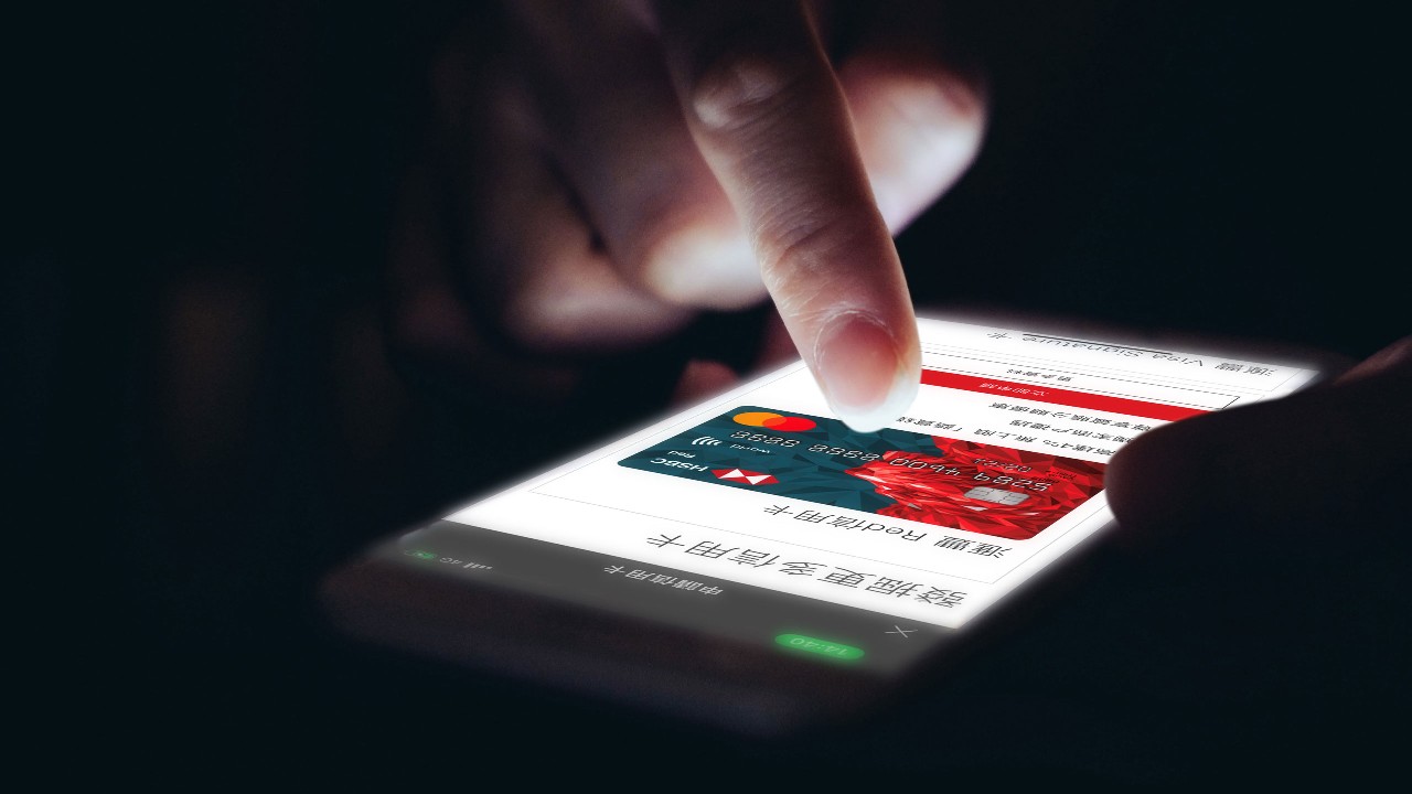 Woman use smartphone to apply for a credit card.