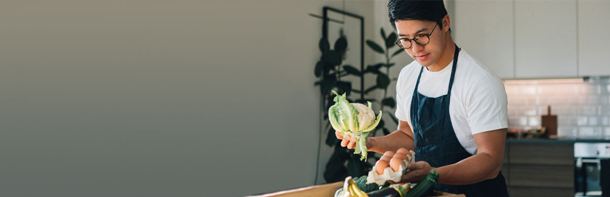 man preparing food for cooking; image used for HSBC Investments Article.