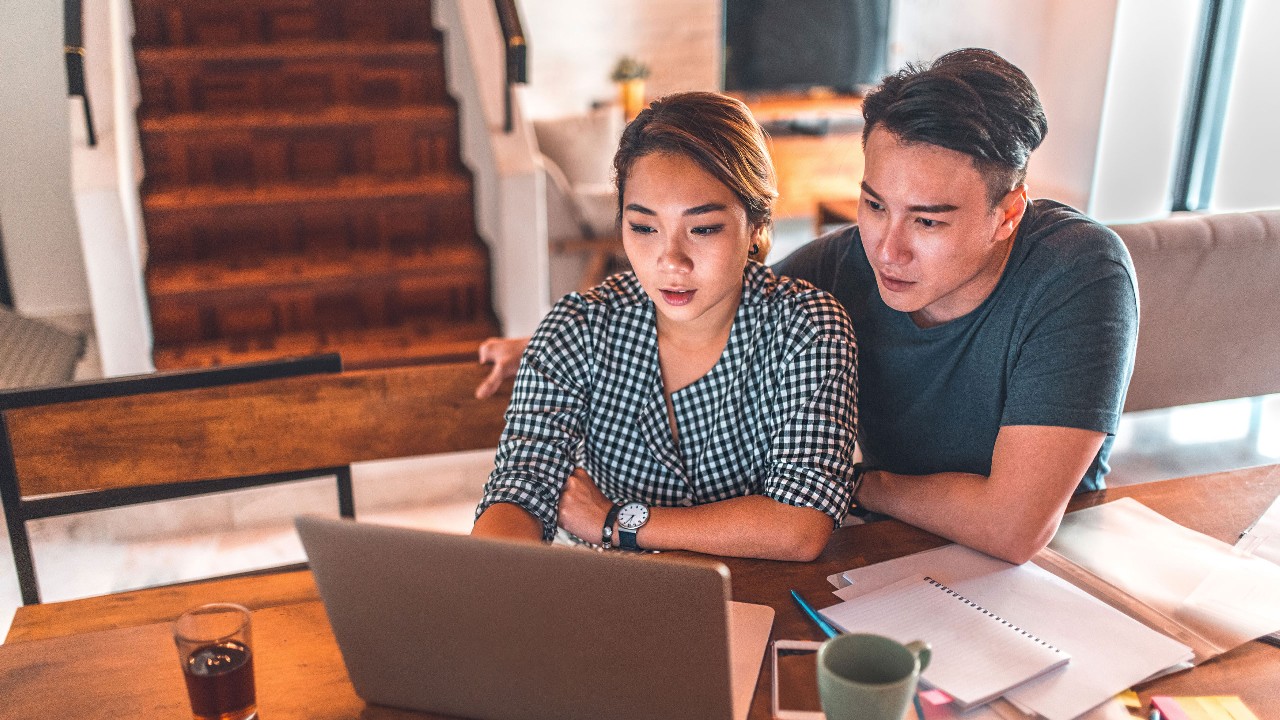 couple looking at a laptop seriously