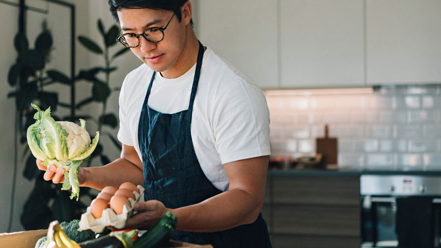 Man preparing ingredients to cook; the image used for "How to build your investment portfolio" article.