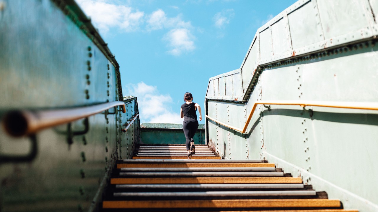 A lady is running up the stairs