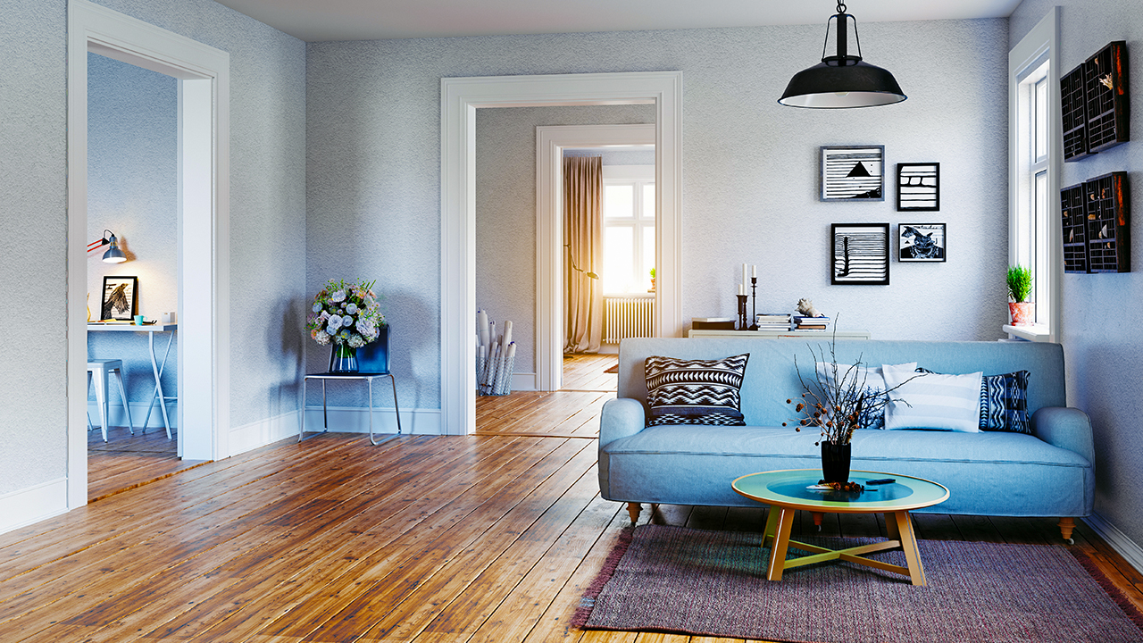 Living room with blue sofa; image used for mortgage assistance
