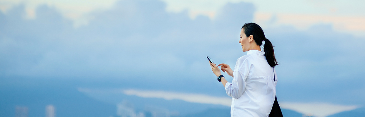 A woman is using smart phone; image used for HSBC Hong Kong open banking.