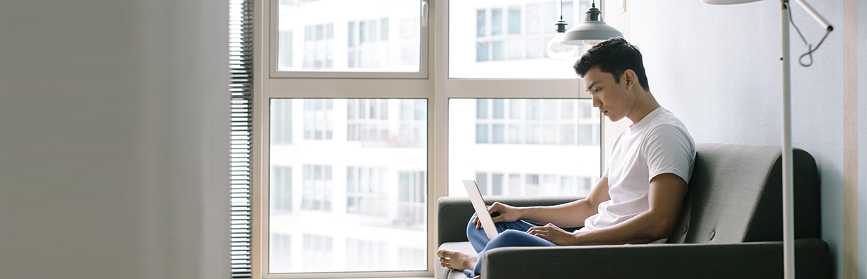 A man is using his laptop; image used for HSBC One Clean Credit