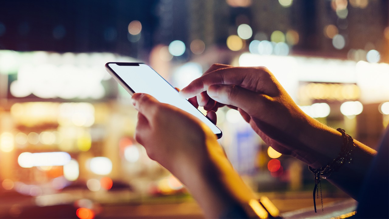 A close-up of hands of a woman who is using a mobile app; image used for the HSBC Hong Kong WeChat page.